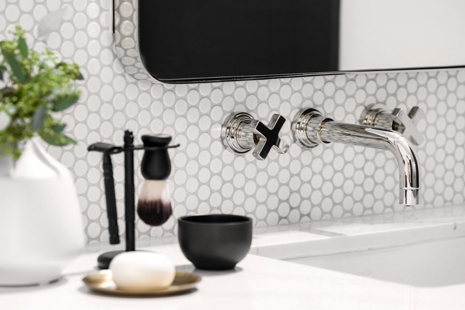 Backsplash with round white tiles and chrome faucet fixture